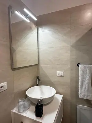 a bathroom with a sink and a mirror at Il falchetto in Palermo