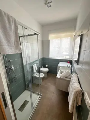 a bathroom with a shower and a toilet and a sink at Il falchetto in Palermo