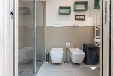 a bathroom with a shower and a toilet and a sink at Lumar Sicilia - Quaroni in Palermo