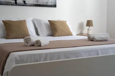 a bed with two towels on top of it at Lumar Sicilia - Quaroni in Palermo