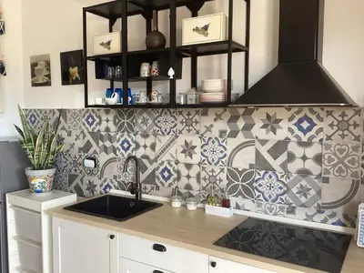 a kitchen with a sink and tiles on the wall at Casa iusu - Home with patio near the sea and Palermo in Casteldaccia