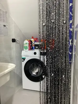a washing machine in a bathroom with a shower curtain at Casa iusu - Home with patio near the sea and Palermo in Casteldaccia