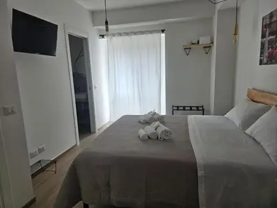 a bedroom with a bed with two stuffed animals on it at Porta D ossuna comfort apartments in Palermo