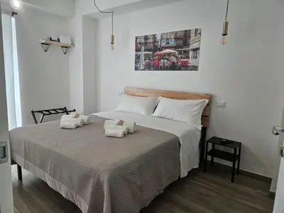 a bedroom with a bed with two towels on it at Porta D ossuna comfort apartments in Palermo