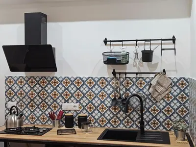 a kitchen with a sink and a tile wall at Porta D ossuna comfort apartments in Palermo