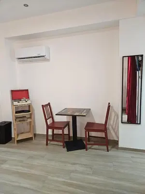 a room with a table and two chairs and a desk at Porta D ossuna comfort apartments in Palermo
