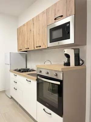 a kitchen with a stove and a microwave at Nela Appartament in Bagheria