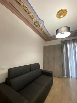 a living room with a couch and a ceiling at Casa Nonna Lina in Isola delle Femmine