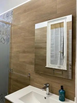 a bathroom with a sink and a mirror at Casa Nonna Lina in Isola delle Femmine