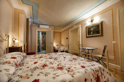 a bedroom with a bed with a floral bedspread at Francy House in Termini Imerese