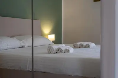 a bedroom with a bed with towels on it at Venere - Alle Spalle del Teatro Massimo in Palermo