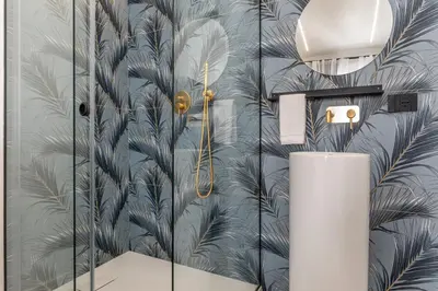 a bathroom with a wall mural of palm trees at Venere - Alle Spalle del Teatro Massimo in Palermo