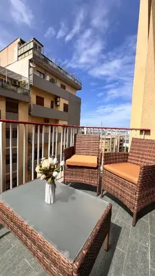 a patio with a table and chairs on a balcony at Kasa Stabile in Palermo