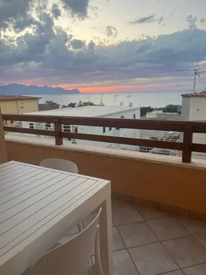 a balcony with a table and a view of the ocean at Profumo di Mare 2 in Alcamo Marina
