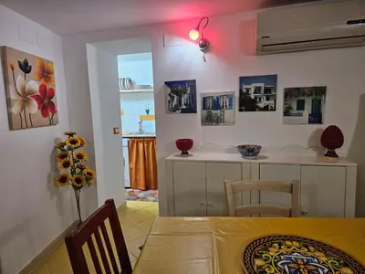 a kitchen with a table and a dining room at Casa Pretoria in Palermo