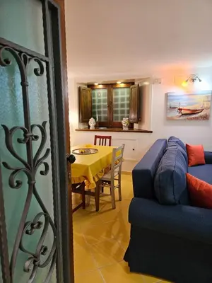 a living room with a blue couch and a table at Casa Pretoria in Palermo