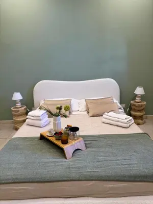 a bedroom with a large bed with a table on it at Domus Fysi in Palermo