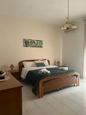 a bed with blankets and towels on top of it at Nonna Ciccina’s House in Vita
