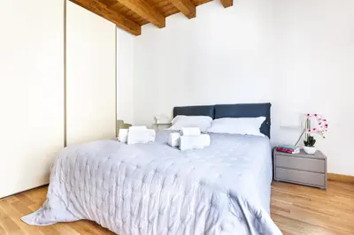 a white bedroom with a large bed with white sheets at Cassari Maisons in Palermo