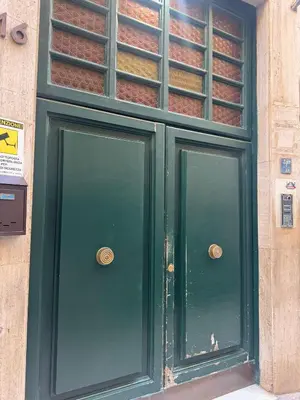 a green door on a building with ajar at Karma House in Palermo