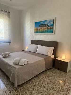 a bedroom with a bed with two towels on it at Karma House in Palermo