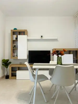 a dining room with a white table and chairs at Casa Iohana in San Vito lo Capo
