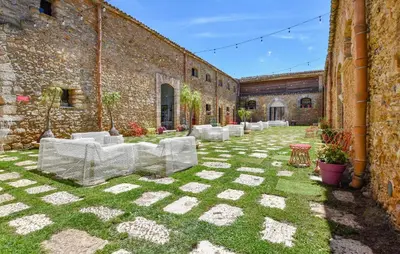 a courtyard with white chairs in a building at 3 Bedroom Amazing Home In Partinico in Partinico