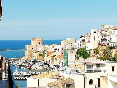a view of a city with boats in a harbor at Casa Marina con vista sul castello in Castellammare del Golfo