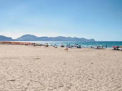 a beach with a bunch of people in the water at Blumare in Balestrate