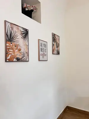 a group of four pictures on a white wall at FM Home Stadio Renzo Barbera in Palermo