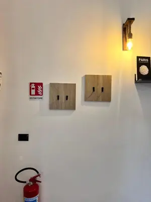 a wall with three wooden boxes on a wall at FM Home Stadio Renzo Barbera in Palermo