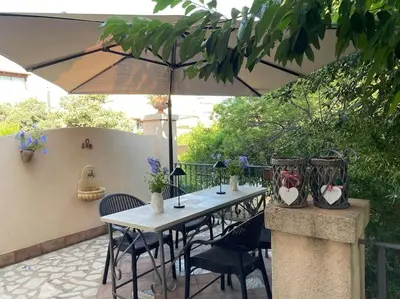 a table and chairs under an umbrella on a patio at Villa Rubino ai Colli in Palermo