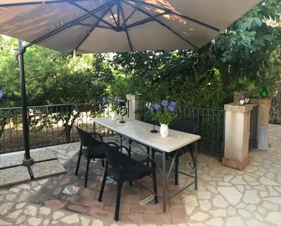 a table and chairs under an umbrella on a patio at Villa Rubino ai Colli in Palermo