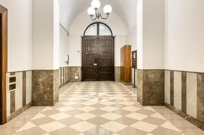 a hallway with a large wooden door in a building at GuestHost - Central Station Modern Apartment with Balconies x8 in Palermo