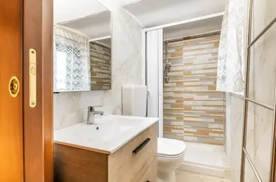 a bathroom with a sink and a toilet at GuestHost - Central Station Modern Apartment with Balconies x8 in Palermo