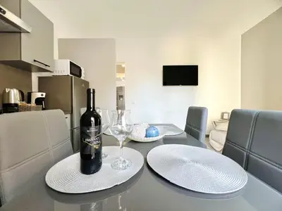 a table with a bottle of wine and a glass at Soevi Appartamenti in Carini