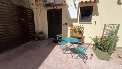 a patio with chairs and a table and a door at LA SPLENDIDA Dimora di Charme - Luxury Loft Palermo in Palermo