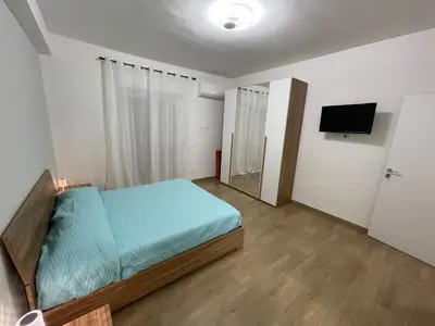 a bedroom with a bed and a flat screen tv at Panormus Guest Apartment in Palermo
