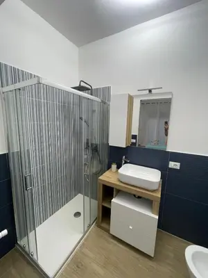 a bathroom with a shower and a toilet and a sink at Panormus Guest Apartment in Palermo