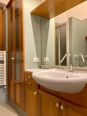 a bathroom with a white sink and a mirror at Villa Orlando Mondello in Palermo