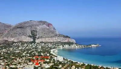 a view of a city with a mountain and the ocean at Villa Orlando Mondello in Palermo