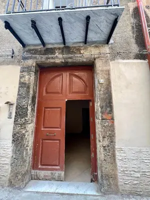 a red door in a building with a doorway at Masalia Loft in Palermo