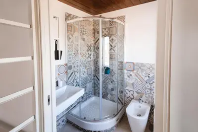 a bathroom with a shower and a tub and a sink at Masalia Loft in Palermo