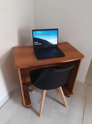 a laptop computer sitting on top of a wooden desk at Makari Sweet Sunsets in Macari