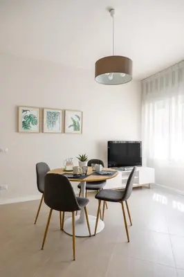 a dining room with a table and chairs at Maison169 in Palermo