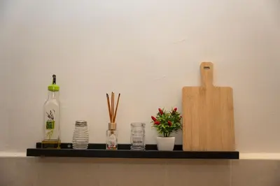 a shelf with bottles and other items on it at LION'S Room in Palermo