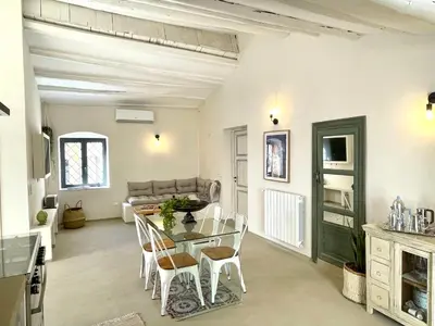 a living room with a table and chairs and a couch at Dream Penthouse over main Square in Palermo