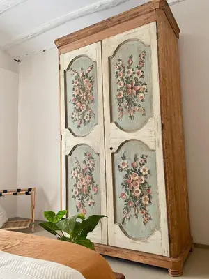 a wooden cabinet with a floral pattern on it in a bedroom at Dream Penthouse over main Square in Palermo