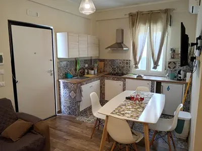 a small kitchen with a table and chairs in a room at Virginia Holiday Home in Mondello