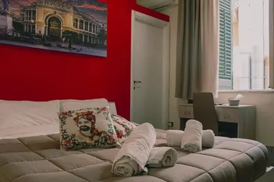 a bedroom with a bed with towels on it at Mizzica Rooms in Palermo